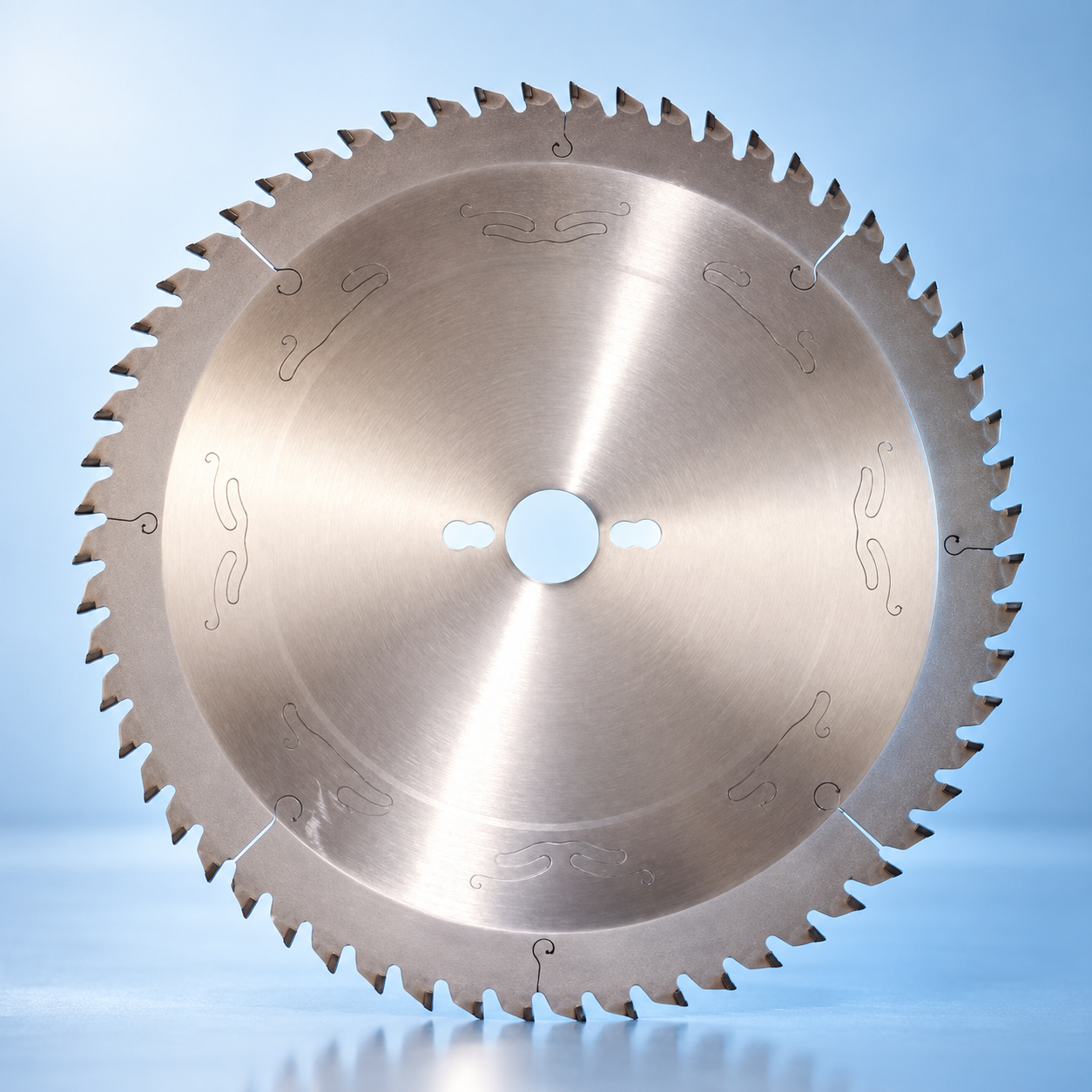 Microtech circular saw blade with carbide teeth on a light blue reflective stage
