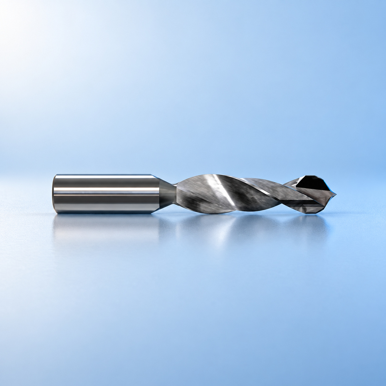 Microtech drill bit with spiral body and cutting head on a light blue reflective stage