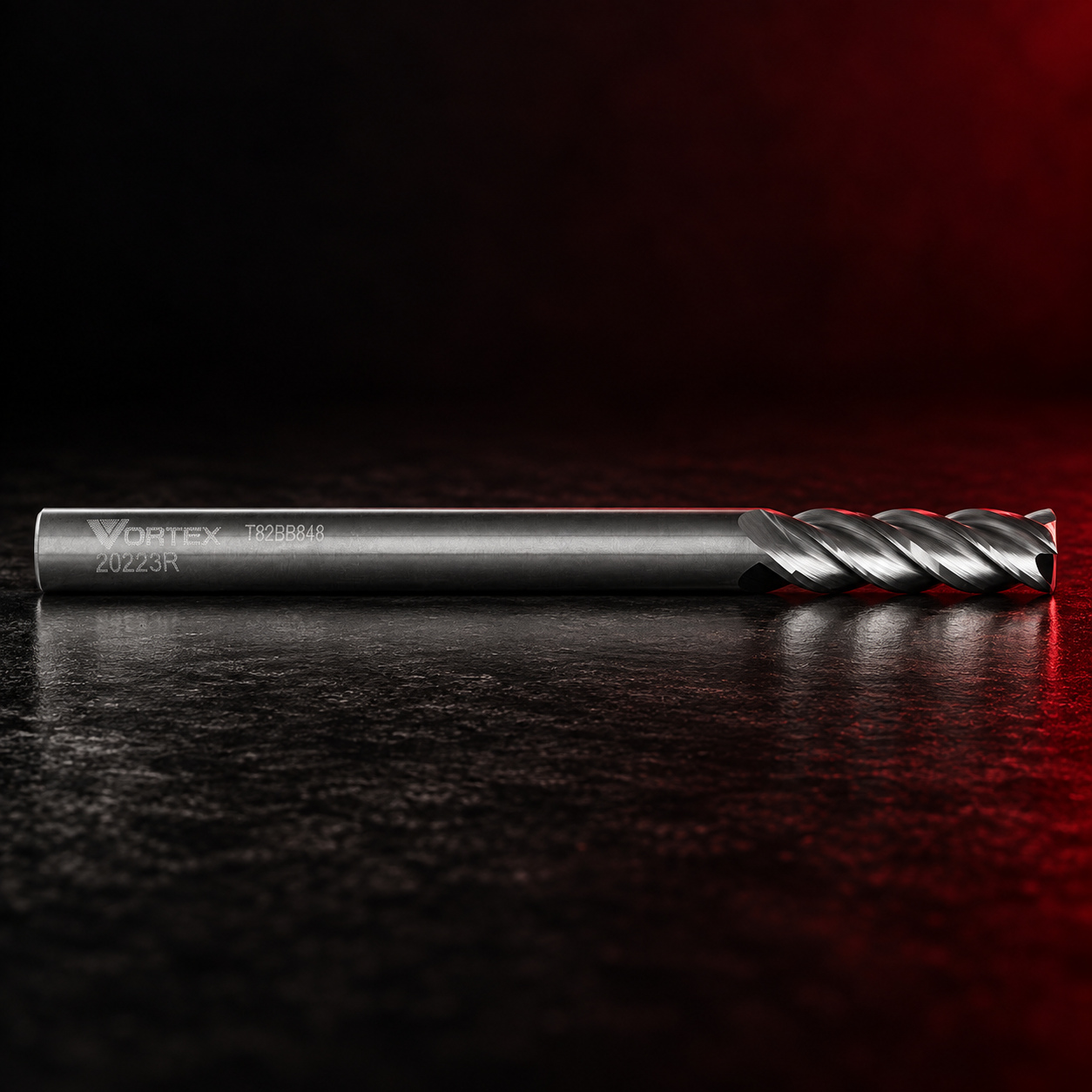 Vortex Tool spiral end mill on a black studio surface with red edge lighting